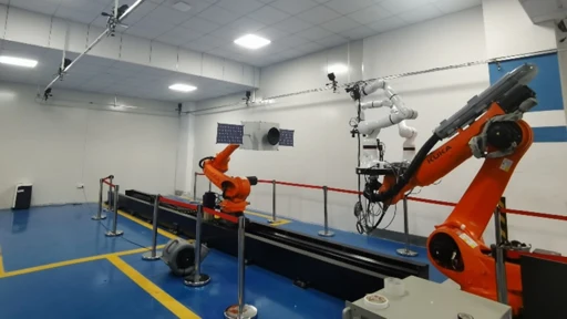 A robotic arm equipped with a vision sensor and a robotic arm equipped with a spacecraft model under the motion capture system